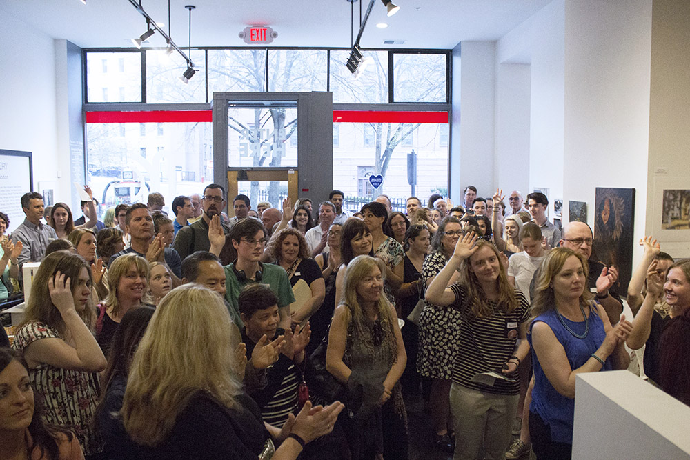 Student artists raising their hands at the High School Regional Award Reception