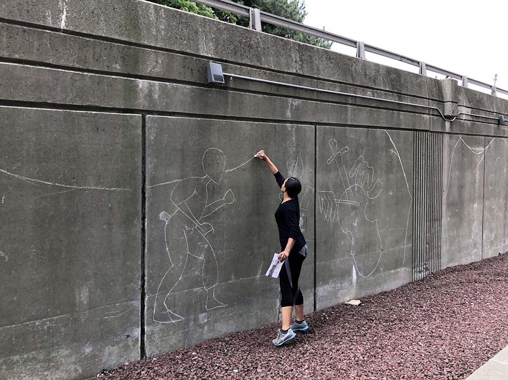 Artist Liz Zunon sketches her vibrant mural on the Clinton Ave ramp off 787 as part of the #CapitalWalls Mural Project