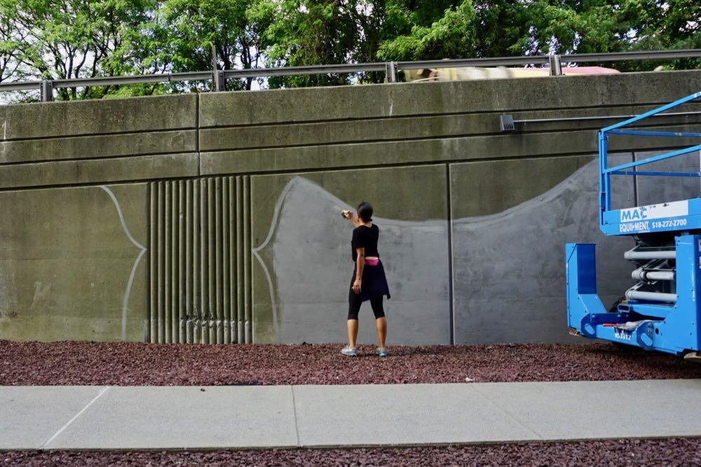 Artist Liz Zunon priming for the mural