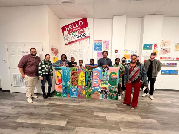 Young artists pose with their "DREAM BIG" mural on Oct. 14, 2022 at Albany Center Gallery's Art.Work.Space in Albany N.Y. They created the mural during a summer-long Summer Meals Collaborative program that connected kids to arts programming and regular meals, thanks to a collaboration with Albany Center Gallery, Albany Housing Authority and United Way of the Greater Capital Region.